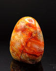 Natürlicher Carneol, fördert energetische Harmonie, orange Oberfläche.
