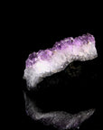 Tiefvioletter Amethyst Kristall, fördert energetische Harmonie, violette glänzende Oberfläche.