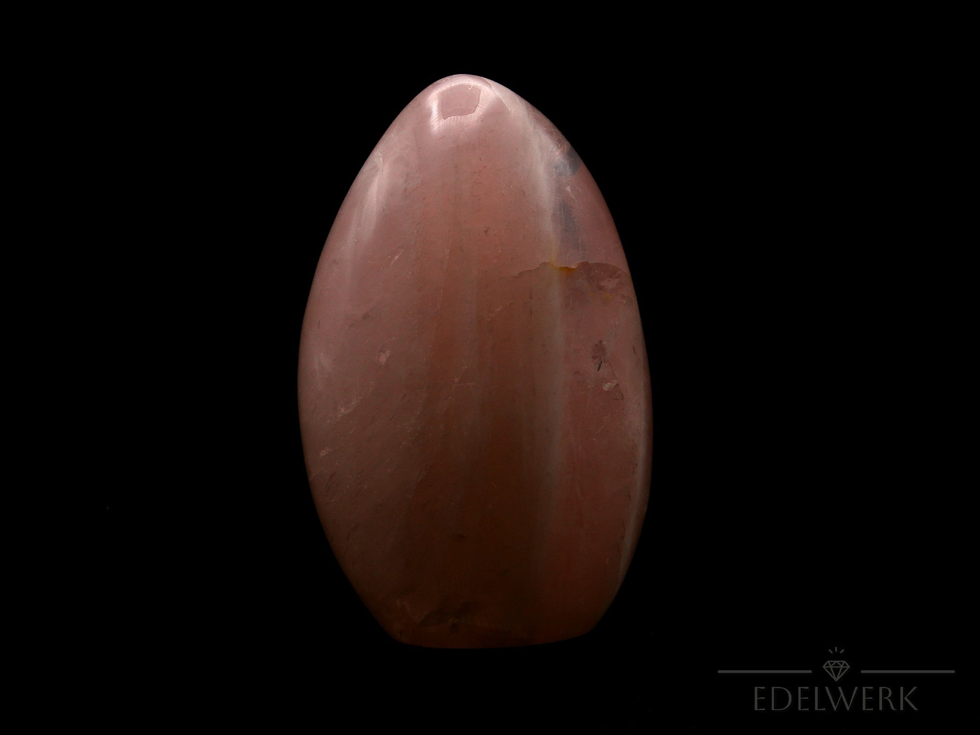 Rosenquarz Heilstein, Heilstein für meditative Klarheit, rosa glänzende Form.