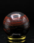 Tigeraugen Kugel Planet, Heilstein für innere Harmonie, glänzende gold-braune Form.
