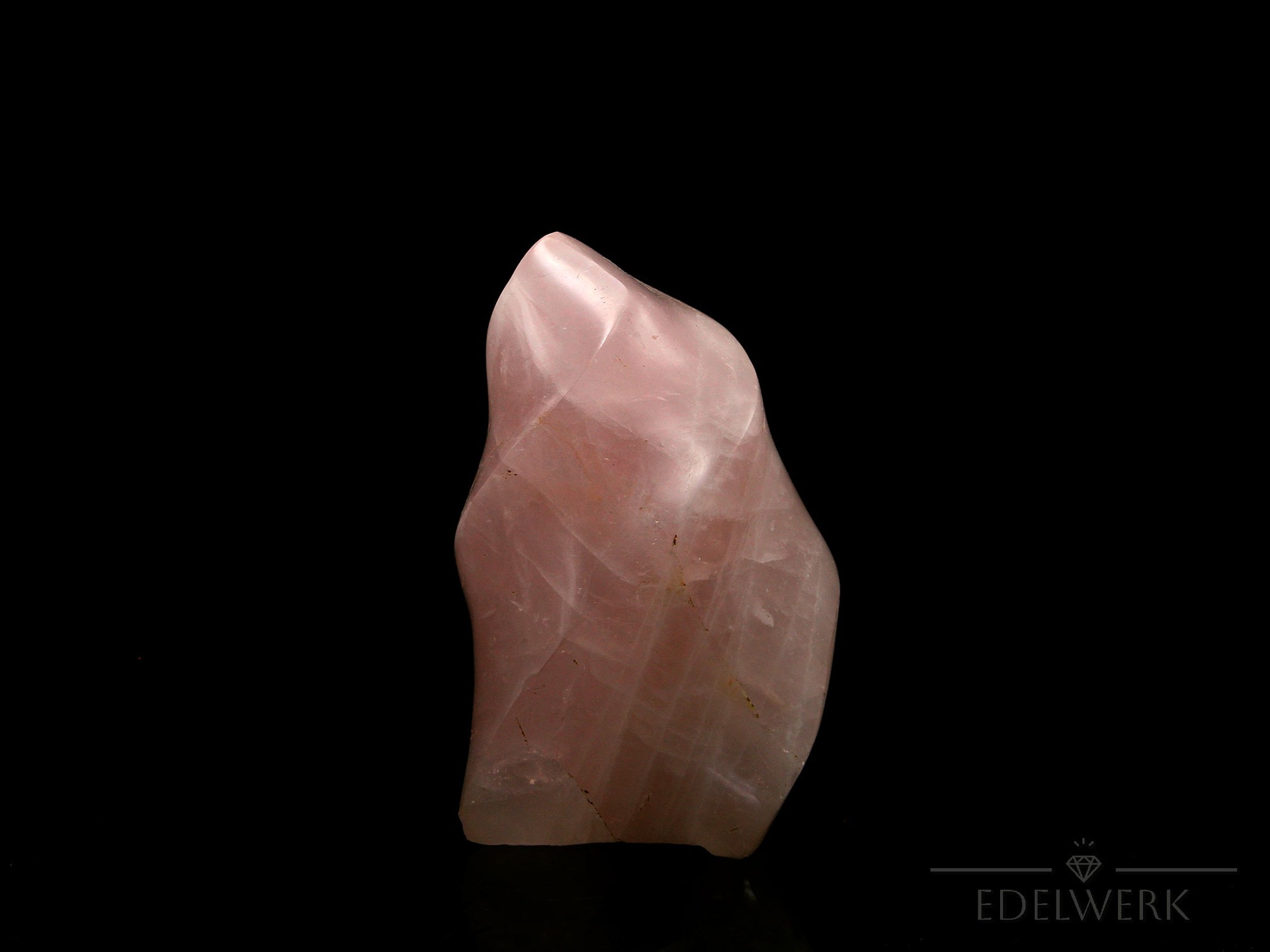 Klarer Rosenquarz, fördert spirituelle Ruhe, durchsichtige rosa Oberfläche.